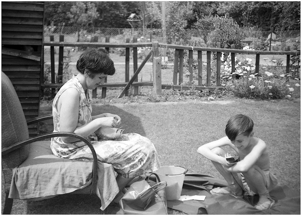 Hilda shelling peas & John texting on the world's first mobile.